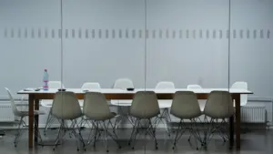 Moderner, leerer Konferenzraum mit langem Tisch für fokussiertes Arbeiten im Büro.